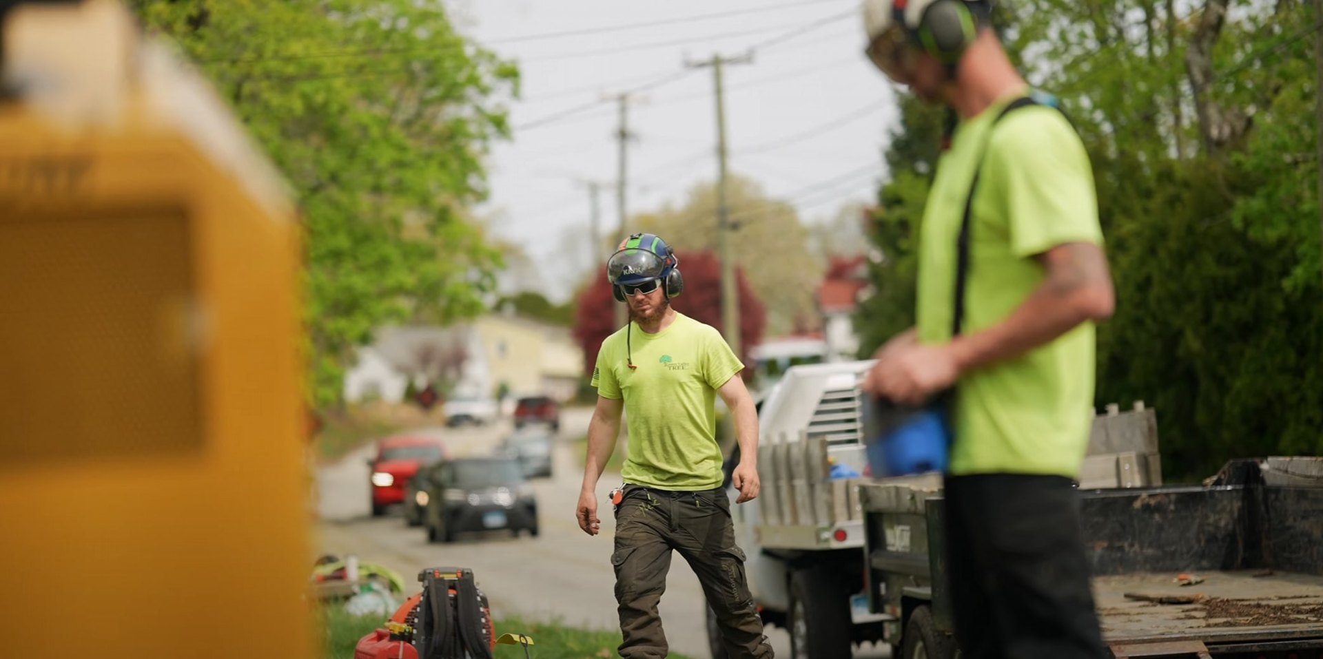 Professional tree service team providing residential tree care Tree service crew working on residential street with professional equipment